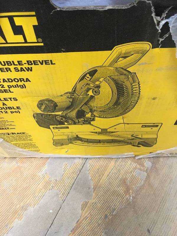 lot 1 image: DeWalt 15 Amp 12 in. Double-Bevel Compound Miter Saw with XPS Light  not used like new