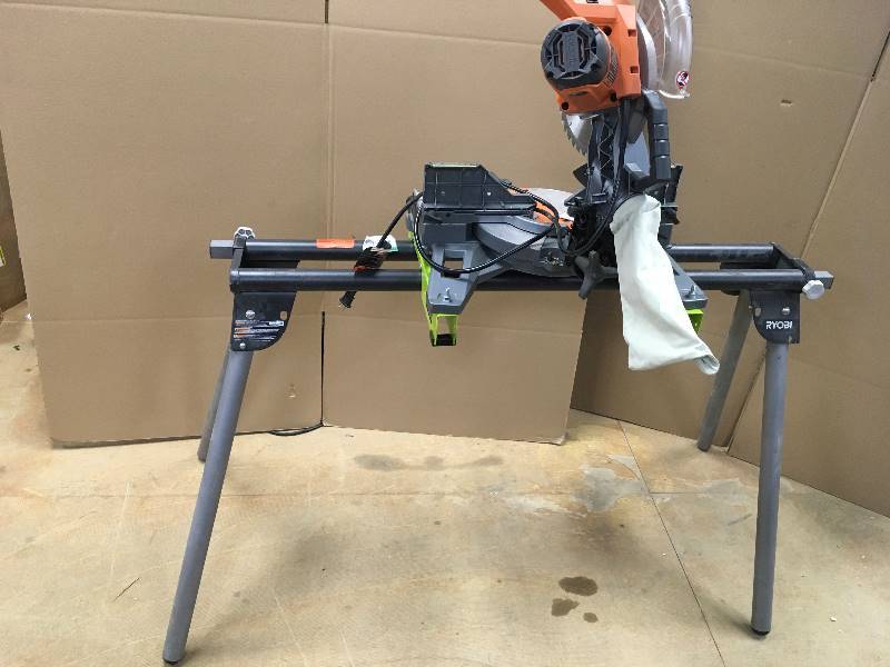 lot 4 image: RIDGID 15 Amp 10 in. Dual Bevel Miter Saw whit Ryobi Stand in working conditions