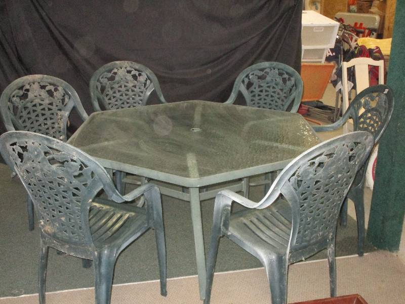 lot 12 image: MetalGlass Patio Table and 6 Stackable Plastic Chairs. Not perfect but would work for anyone