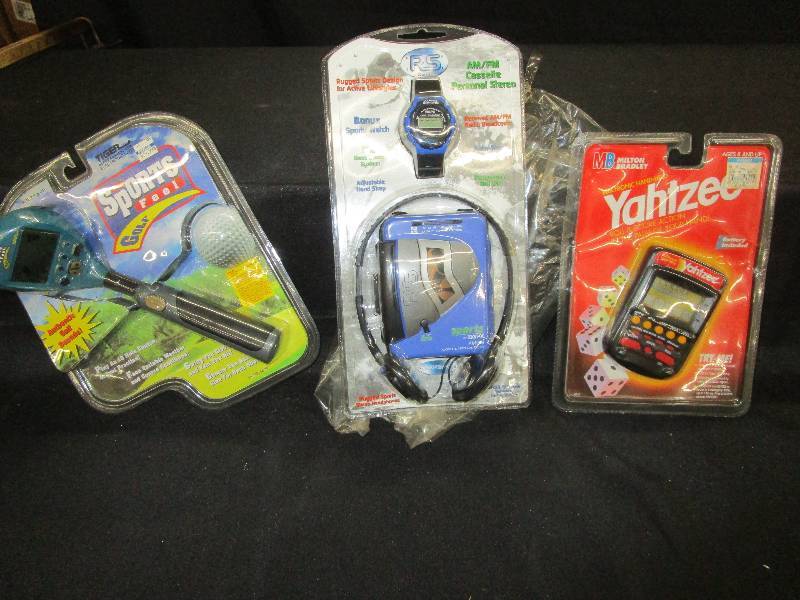 lot 84 image: Golf Game, Yahtzee game and Walkman all in packages