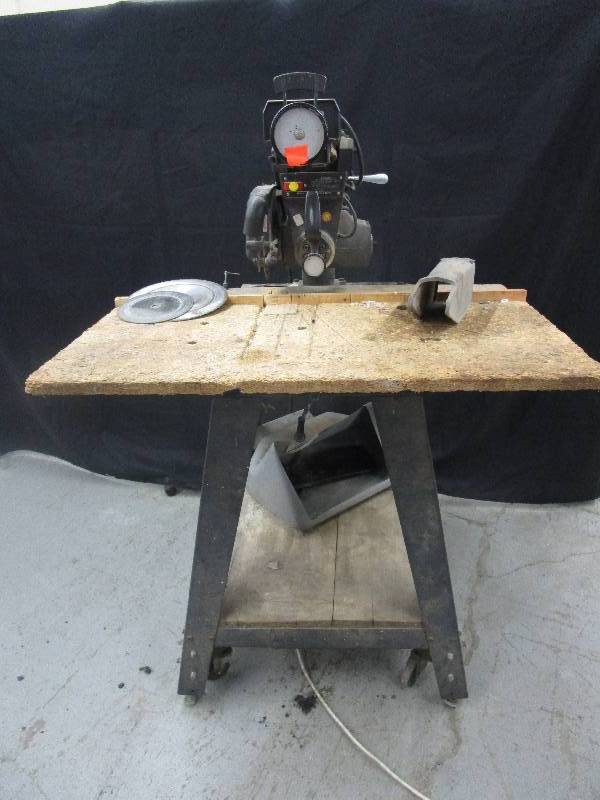 lot 188 image: Sears Craftman Table Saw with 10 Radial Dial on Cart with Wheels and extra Blades. There is also a dust Collector Tray