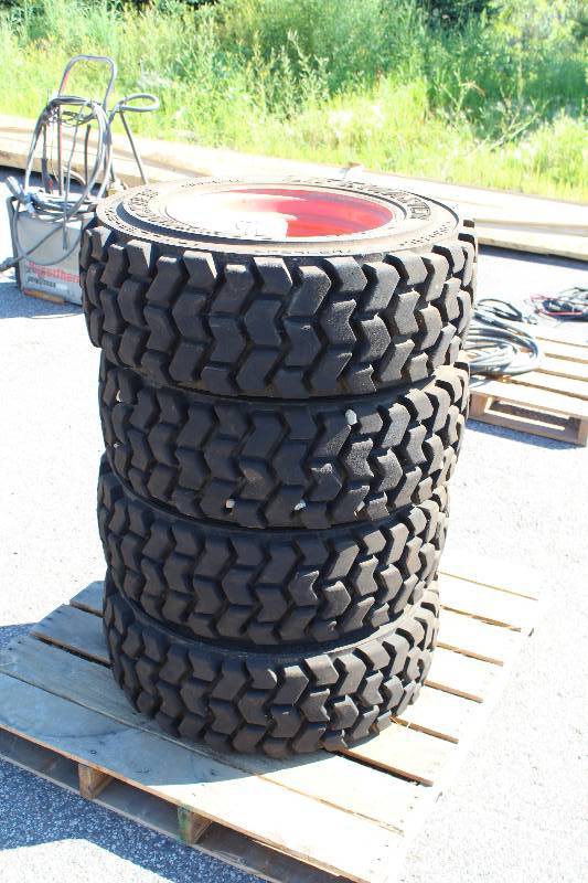 lot 125 image: Lot of (4) Lifemaster 10-16.5 Bobcat Tires w 8-Lug Wheels