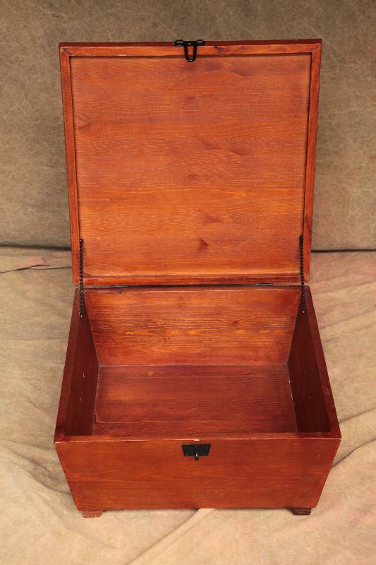 lot 34 image: Market Bazaar Wooden Storage Box Cherry Toned Wood Box With Trapezoid Sides, Black Iron Locking Latch and Side Handles. 20x20x9 Great Condition