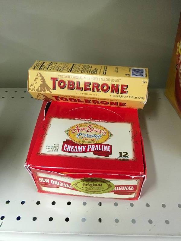 lot 62 image: Toblerone Milk Chocolate & Aunt Sallys Pralines, Retail $22.78