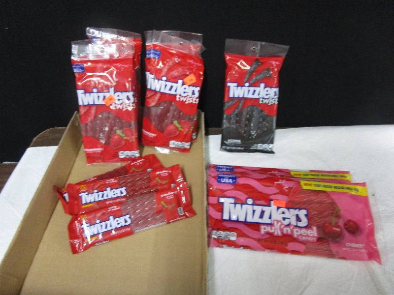lot 53 image: 9 strawerry twizzler twists, 1 black licorce, 2 pull n peels cherry