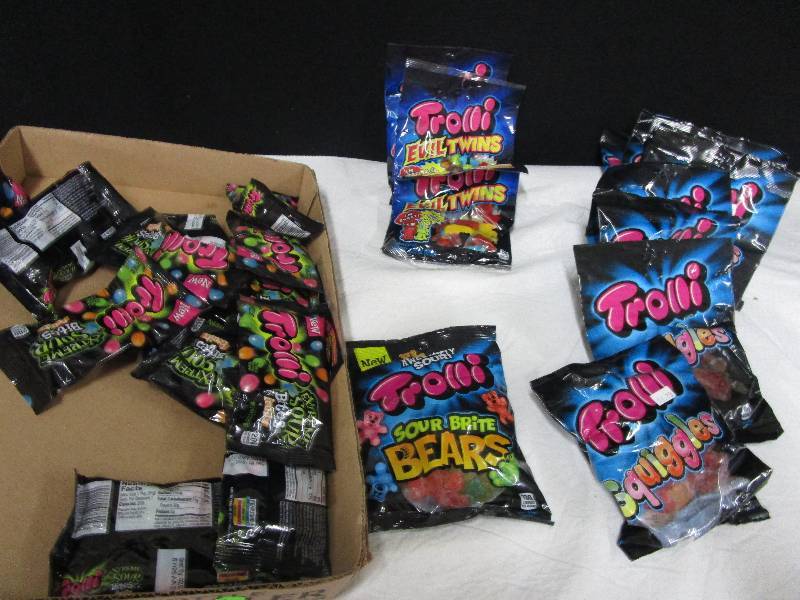 lot 99 image: 8 Trolli Squiggles, 3 Trolli Evil Twins, 1 sour brite bears, 13 Trolli extreme Sour Bites