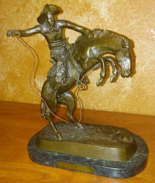 lot 55 image: Woolly Chaps by Frederick Remington, Bronze Granite Base, Weighs a whopping 9 pounds