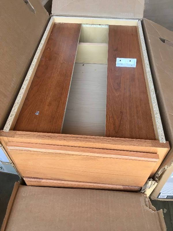 lot 18 image: Hampton Bay 15 in Base Cabinet Madison Medium Oak Finish 15 in W x 34.5 in H x 24 in D whit small damage please review the pictures not used
