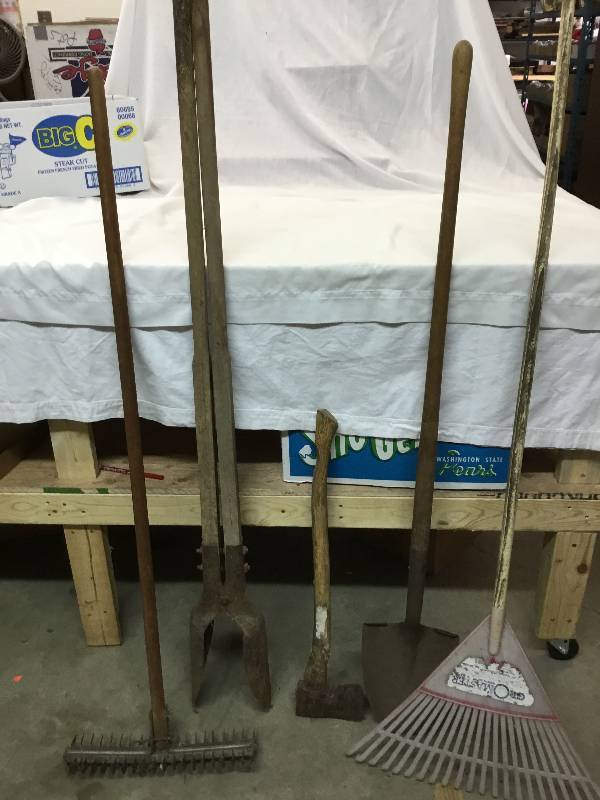 lot 34 image: Hand tools 2 rakes, post digger, shovel and axe.