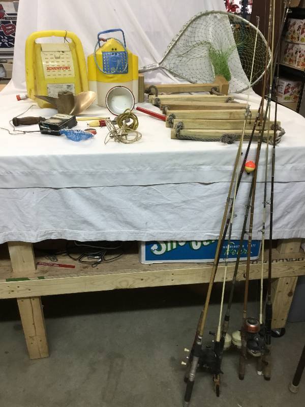 lot 39 image: Large amount of fishing items 8 poles, nets, prop minnow buckets and others.