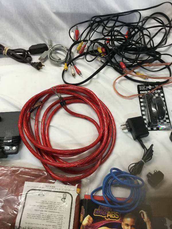 lot 63 image: Electronics lot remotes PlayStation games cables  dvd player cat 5 extender