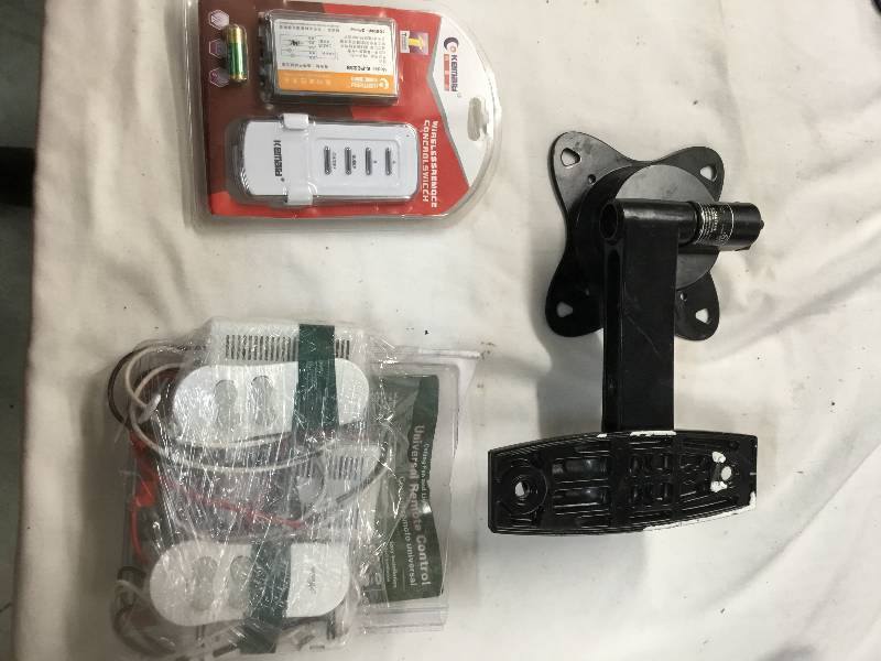 lot 87 image: 4 ceiling fan remotes, TV wall mount, 10 Marine lanyards
