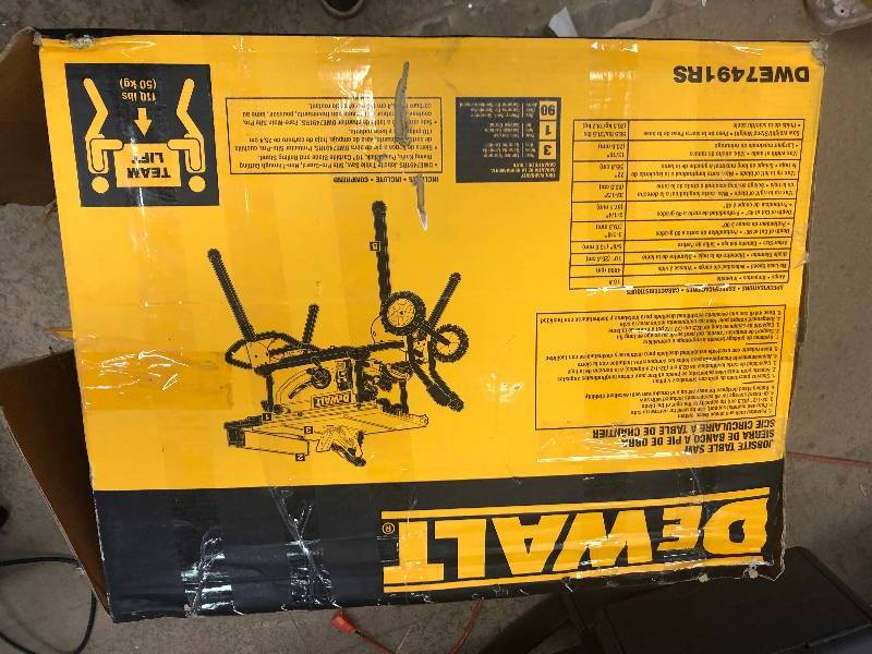 lot 104 image: DEWALT 15-Amp Corded 10 in. Job Site Table Saw with Rolling Stand in like New working conditions