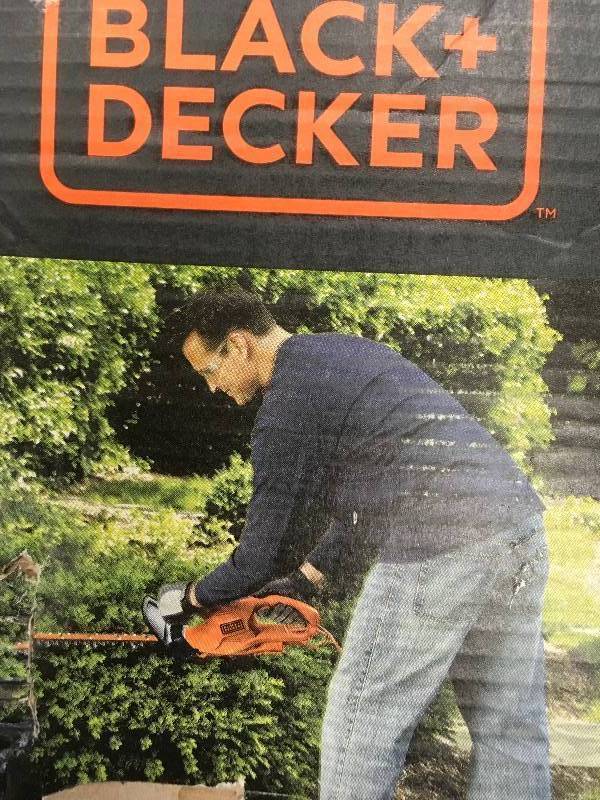 Black and Decker 16 in. 3.0 Amp Corded Electric Hedge Trimmer in working conditions