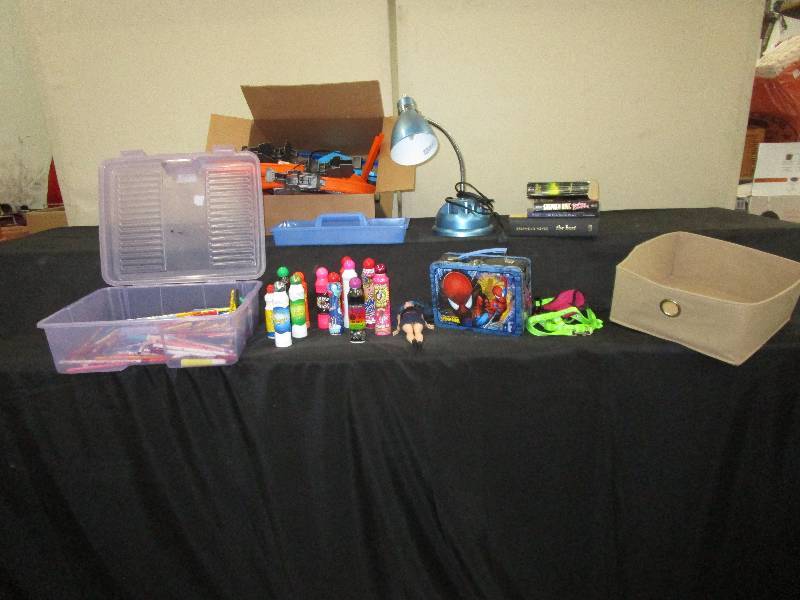 lot 63 image: Assortment of Pens, Pencils, Markers, Bingo Markers, Lamp (works), Tin Lunchbox, Books, Barbie Doll, Basket