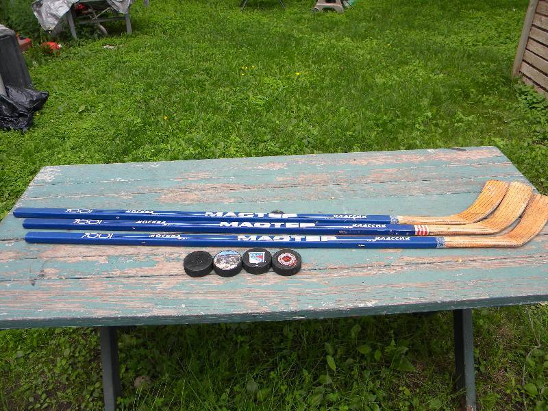3 Hockey Sticks & 4 Pucks