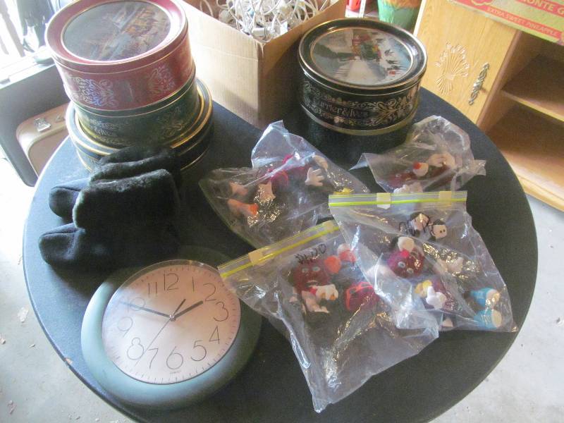 lot 52 image: Womens Slippers, 5 Cookie Tins, Christmas Lights and Villages, Clock, California Raisin figurines