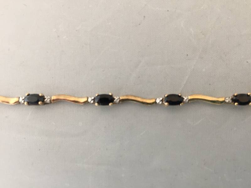 lot 83 image: 10K Gold Bracelet - Dark Blue Stones