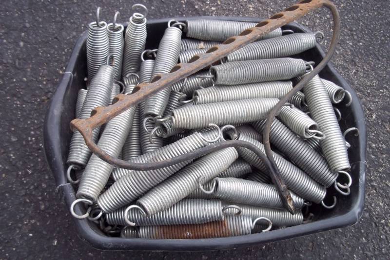 Trampoline springs with lawn rake head