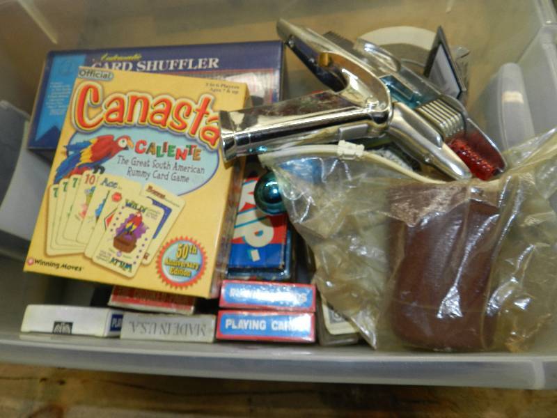 lot 542 image: SMALL TOTE OF MISC GAMES, CARDS, TOY SPACE RAY GUN AND MORE