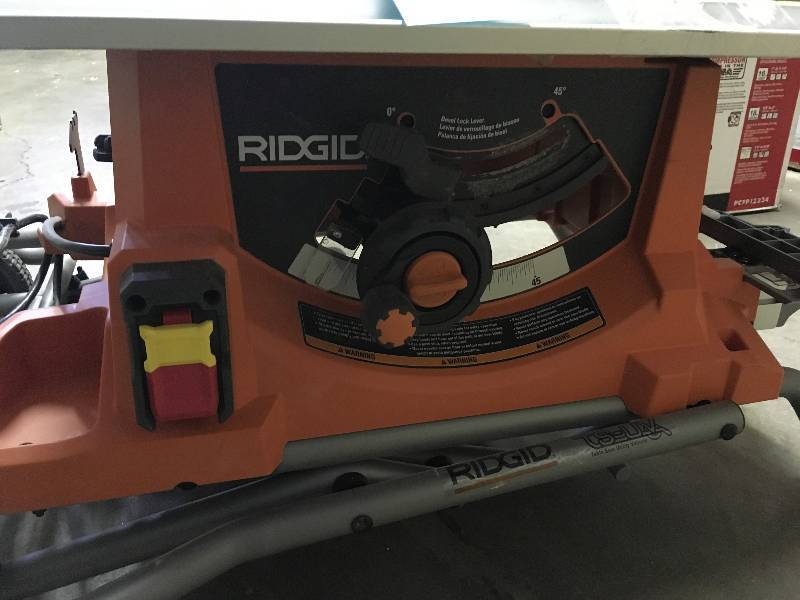 lot 10 image: RIDGID  15 Amp 10 in. Heavy-Duty Portable Table Saw with Stand in working conditions