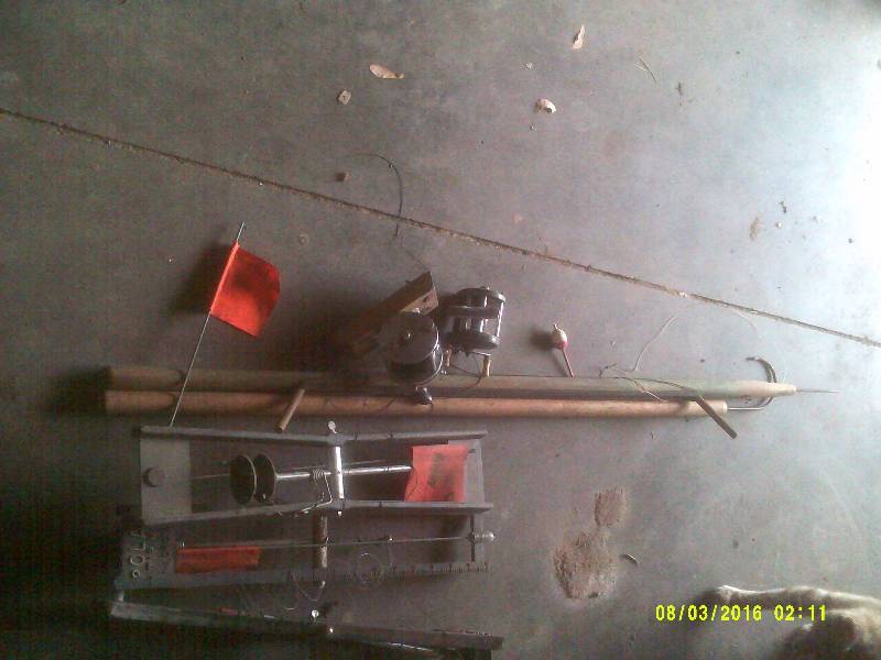 lot 36 image: 1 ANTIQUE ICE FISHING ROD 1 ANT GRABBER REELS , ALSO TIP UPS