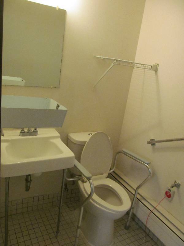 lot 127 image: (Rm37) Bathroom sink, toilet, wire rack, dispenser, mirror