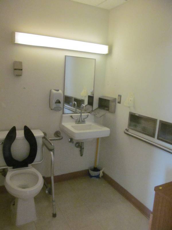 lot 141 image: (Rm 36) Bathroom, toilet, sink, mirror, dispensers