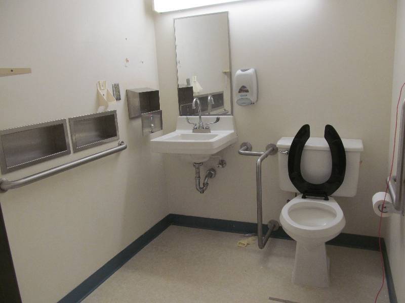 lot 198 image: Rm 32-Toilet sink, 3 handrails, shelf, dispensers(soap and towel), and mirror