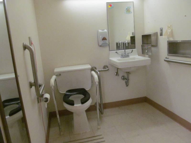 lot 216 image: Rm 31- Sink, toilet, mirrors, soaptowel dispensers, and 3 hand rails