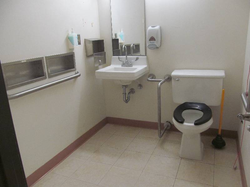 lot 247 image: Rm 27-Bathroom, toilet, sink, wall mirror, 3 handrails, towel, and soap dispenser