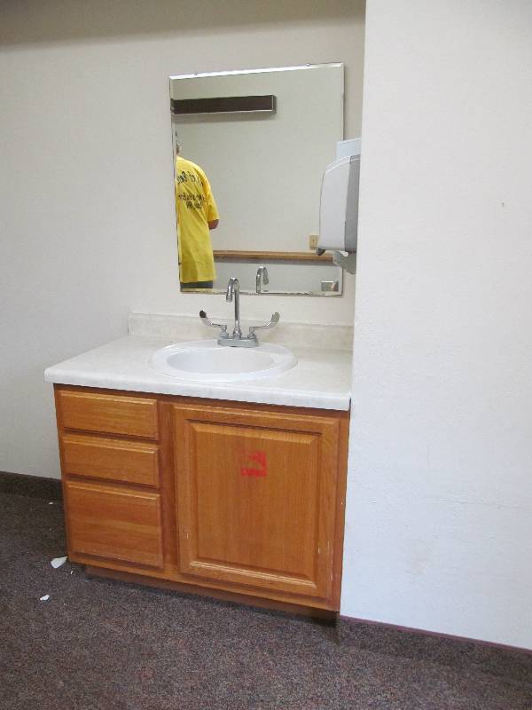 lot 309 image: Rm 23-Vanity mirror, towel and soap dispenser.