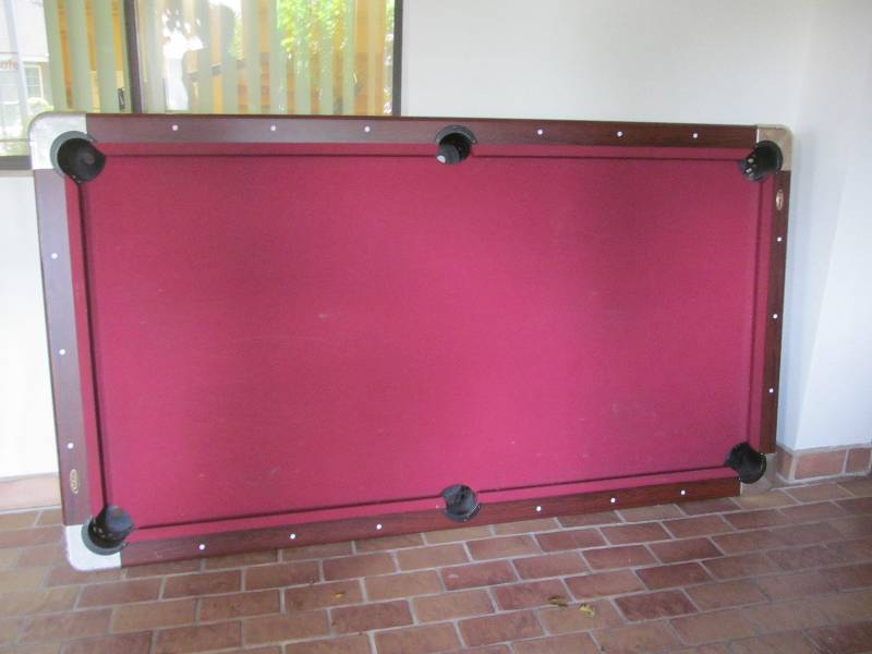 lot 438 image: Cleaning room-6 pool cues, pool table, chalk rack