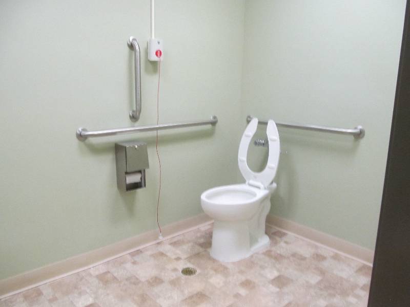 lot 694 image: Rm 11- Unisex Bathroom toilet, sink, soap & towel dispense, and handrails