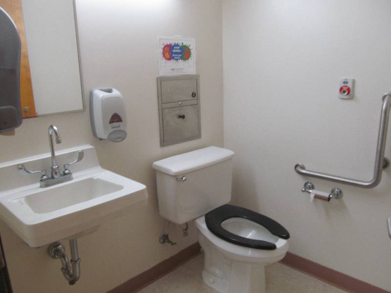 lot 780 image: Bathroom (across from rm 24) Toilet, sink, hand rails, soap and towel dispenser