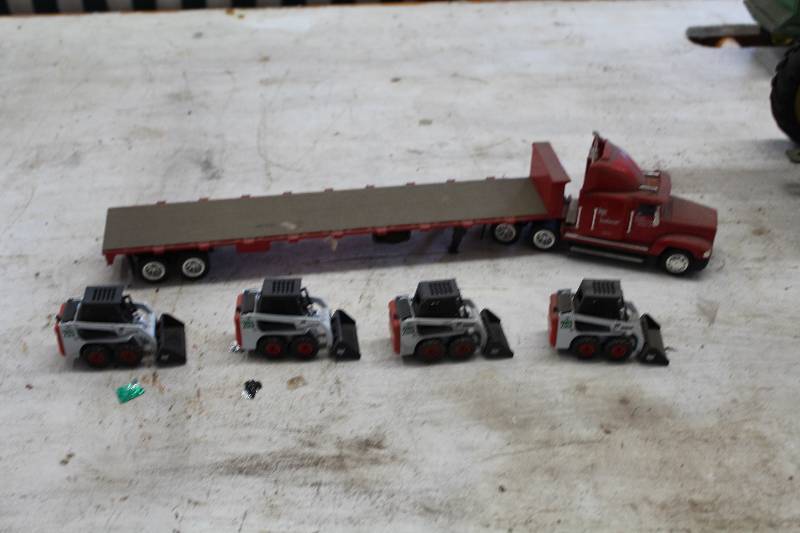 lot 115 image: Semi-Tractor Trailer w 4-Bobcat Loaders w Shovel Attachments