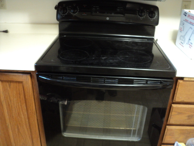lot 6 image: General Electric oven and glass top...