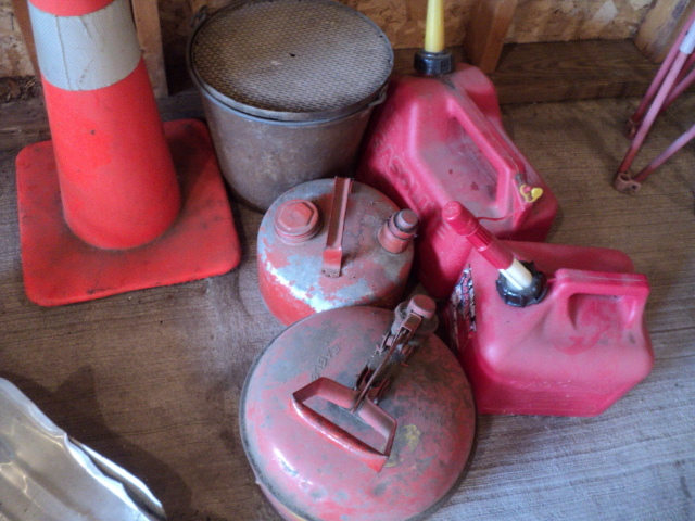 lot 36 image: Lot of gas cans and an orange cone...