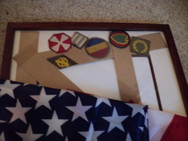 lot 218 image: Framed patches and a flag...