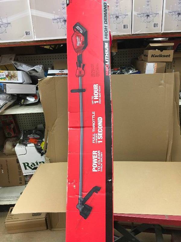 lot 22 image: MILWAUKEE  M18 FUEL 18-Volt Lithium-Ion Brushless Cordless String Trimmer 9.0Ah Battery Kit with Extra M18 5.0 AH Battery in like new working conditions