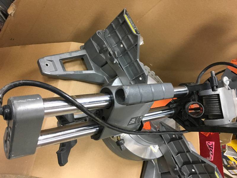 lot 50 image: RIDGID 15 Amp 12 in. Corded Dual Bevel Sliding Miter Saw with 70° Miter Capacity in working conditions
