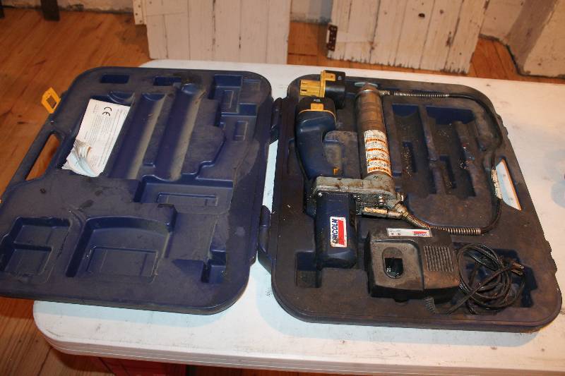 lot 308 image: Lincoln battery powered grease gun with charger and extra battery trigger is sticky.