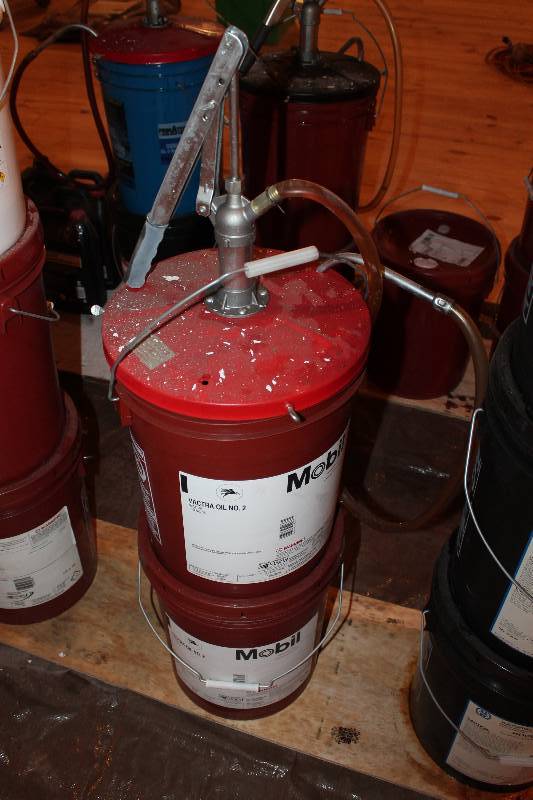 lot 368 image: Two, 5-gallon pails of Machining Way oil. Mobil Vactra oil no. 2. One is new un opened, second is opend and comes with pump.