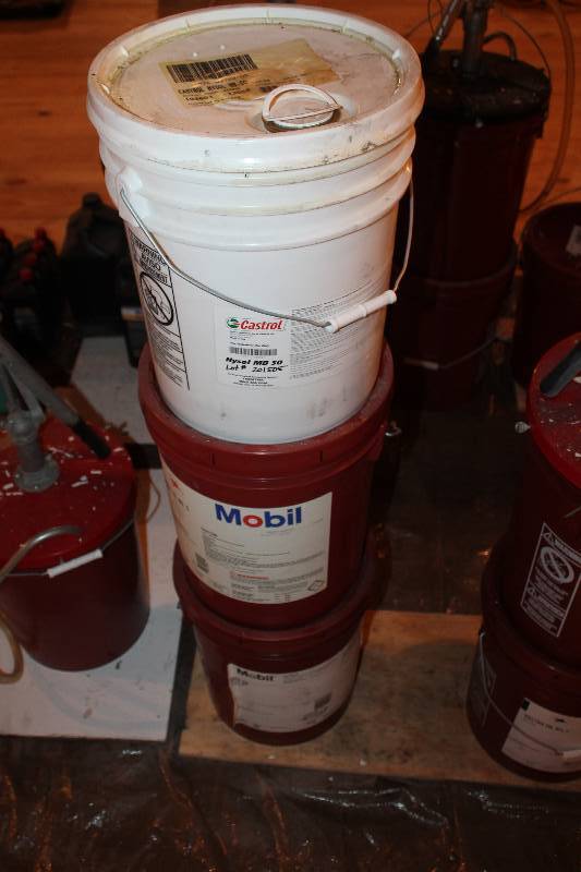 lot 369 image: Lot three different fluids in 5-gallon pales. First is Castrol HYSOL MB-50. Second, Mobil Velocite oil no.3. Third, Mobil Hydraulic oil DTE 24. All have been opened and are less then half full.
