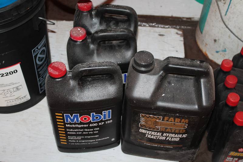 lot 376 image: Lot of (3) 1-gallon jugs of Mobil Industrial gear Oil. Also, One, New  unopened 2-gallon jug of universal hydraulic fluid.