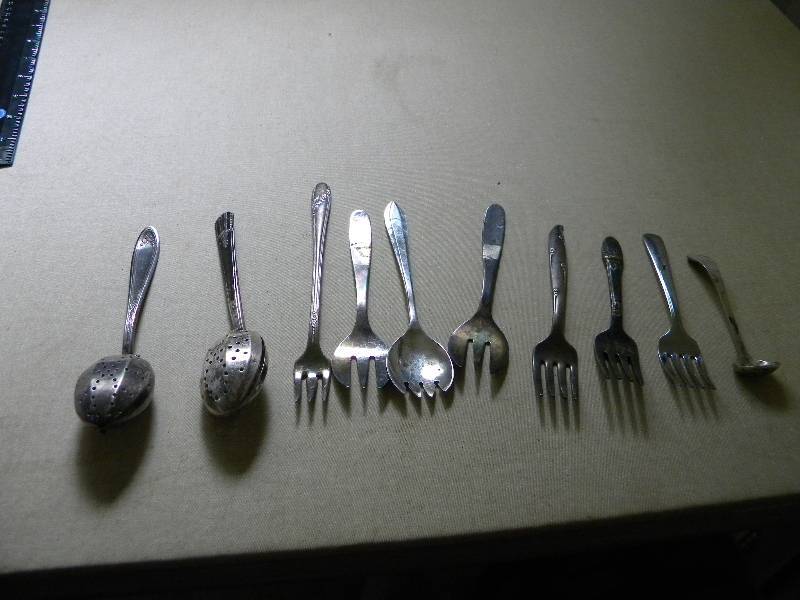 lot 38 image: 10 Flatware Pieces (includes one Sterling Silver piece)