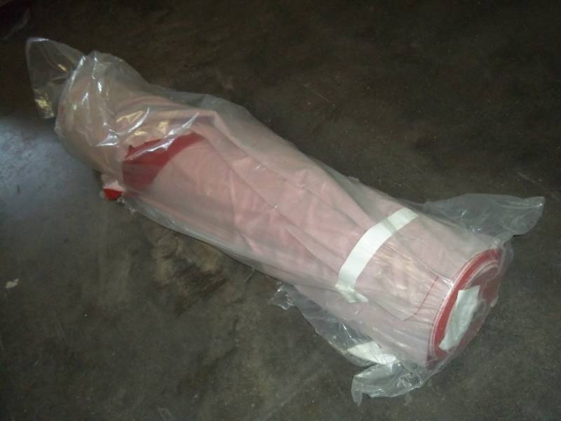 lot 113 image: Roll of Red Fabric 60.3 Yards