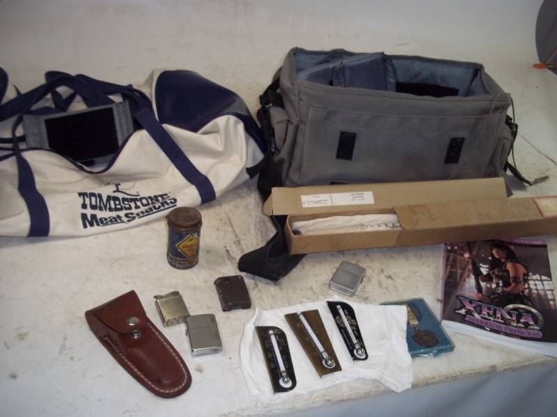 lot 47 image: Tombstone Duffel Bags,Xena Book,Lighters,Incubator Thermometers,Knife Case,Jr. Olympics Metal,Magnet