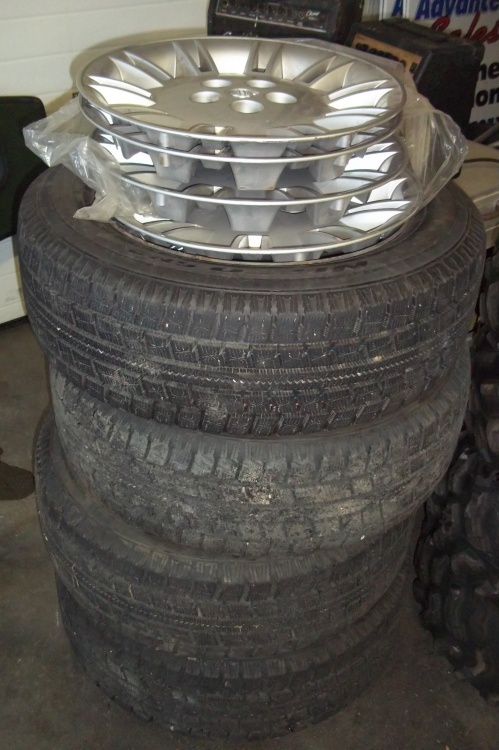 lot 254 image: 4 Snow Tires and Wheels and Hubcaps to fit Dodge Charger 21560R17