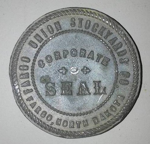lot 261 image: Lunch box ,paper embosser, Fargo Union Stockyard company corporate seal  more